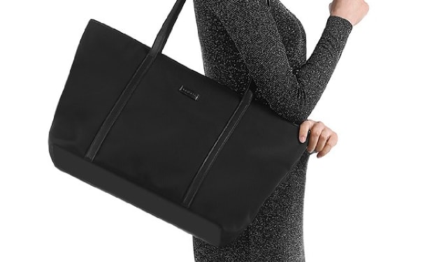Woman carrying a black tote bag